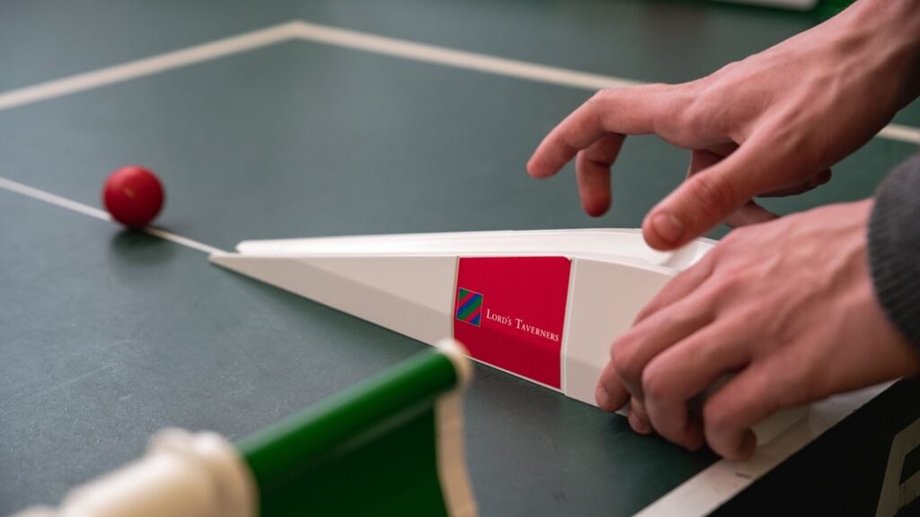 table cricket bowling ramp with ball rolling