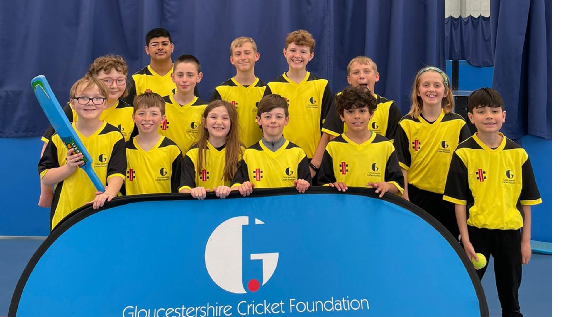 Teams from Chance to Shine Street in yellow shirts standing around GCF Banner 