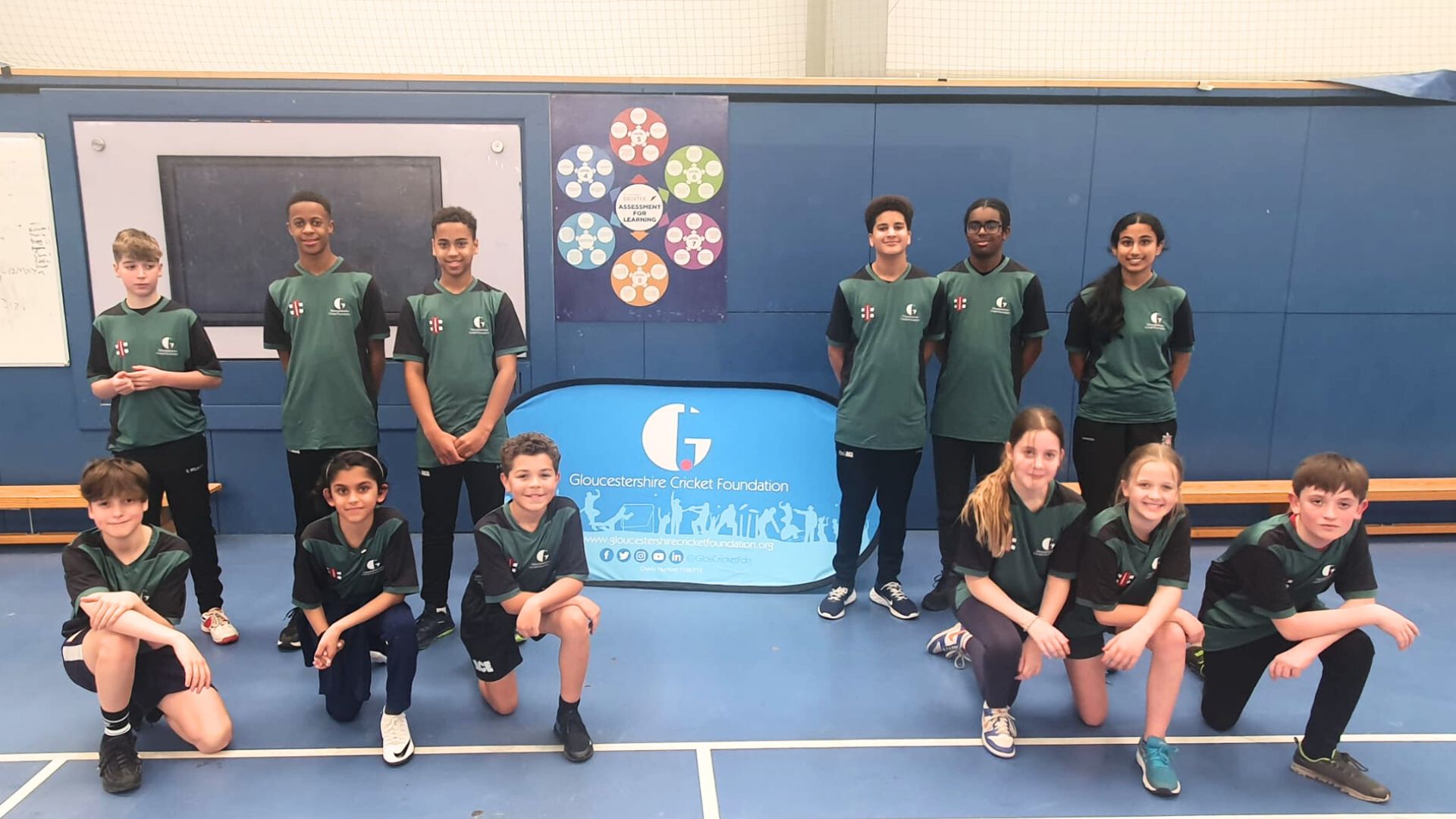 2 teams from ACE programme standing around a GCF banner in green shirts
