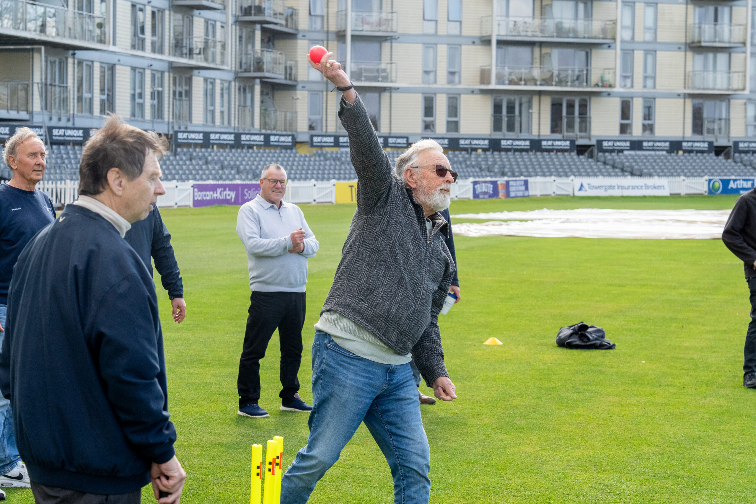 An older man bowls the ball during a walkers and talkers walking cricket taster session