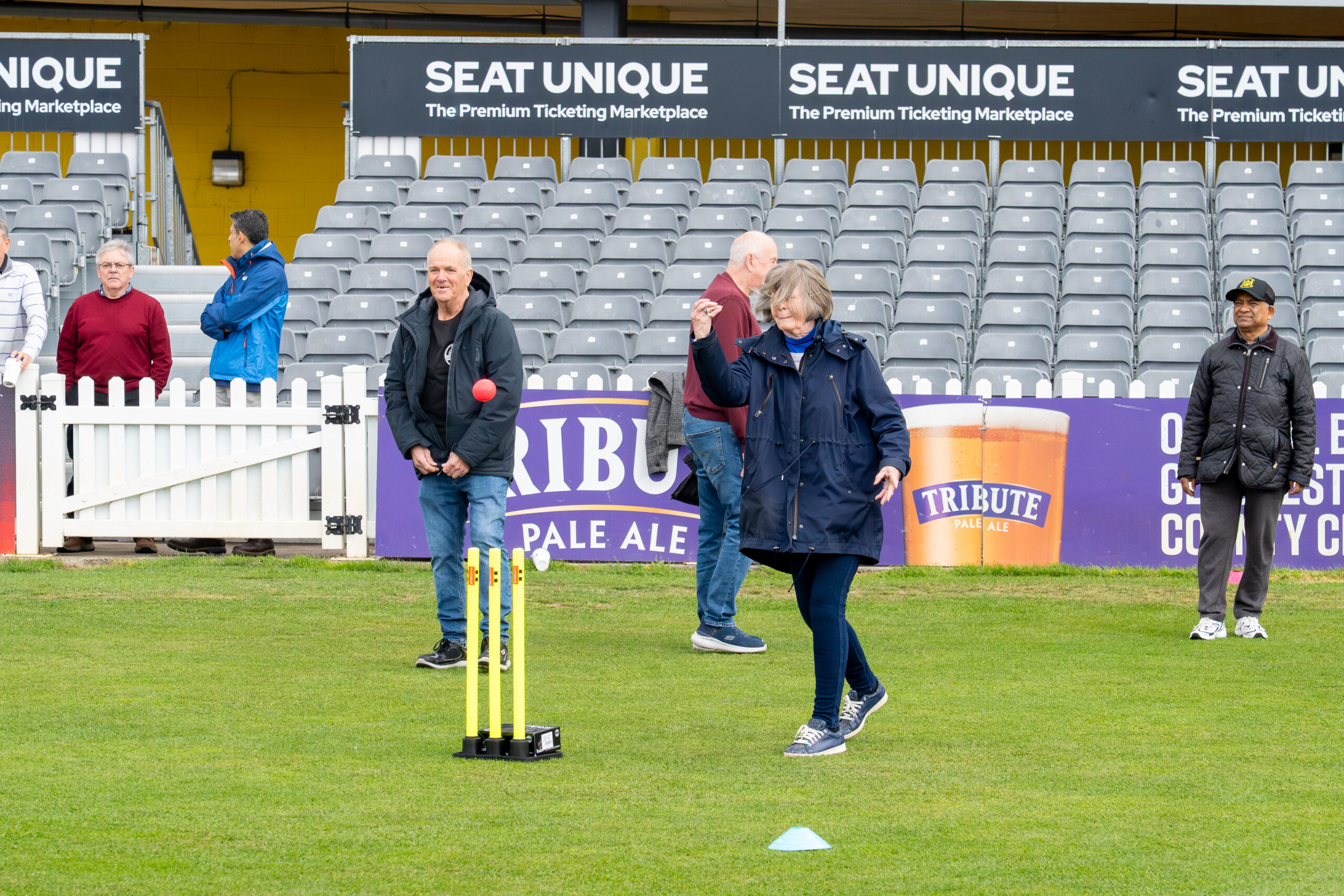 A woman bowls underarm during a walkers and talkers walking cricket session