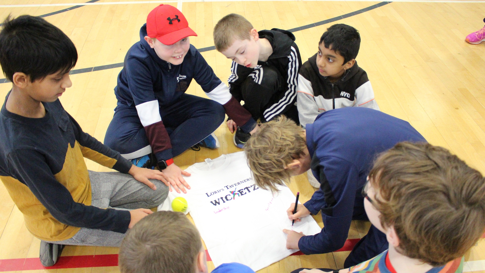 a group of boys designing a Wicketz t-shirt with their team values